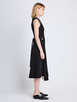 Side full length image of model wearing Ivy Wrap Dress in BLACK