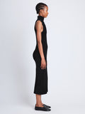 Side full length image of model wearing Dylan Turtleneck Dress in BLACK