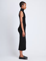 Side full length image of model wearing Dylan Turtleneck Dress in BLACK