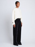 Side full length image of model wearing Tara Sweater in OFF WHITE