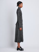 Side full length image of model wearing Avery Turtleneck in BLACK/SILVER