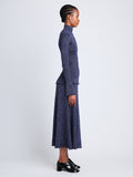 Side full length image of model wearing Avery Turtleneck in ROYAL BLUE/SILVER