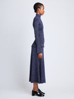 Side full length image of model wearing Avery Turtleneck in ROYAL BLUE/SILVER