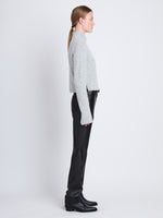Side full length image of model wearing Brigitt Sweater in LIGHT GREY MELANGE