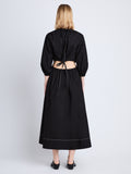 Back full length image of model wearing Nora Backless Dress in BLACK