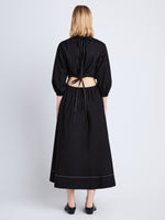 Back full length image of model wearing Nora Backless Dress in BLACK
