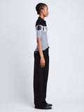 Side full length image of model wearing Louisa Polo in BLACK/ASH