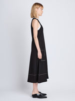 Side full length image of model wearing Lucy Dress in BLACK
