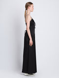 Side full length image of model wearing Harper Backless Dress in BLACK