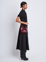 Image of model wearing Extra Small Ruched Tote in GARNET
