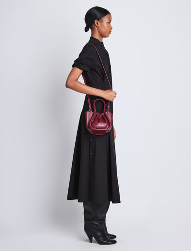 Image of model wearing Extra Small Ruched Tote in GARNET