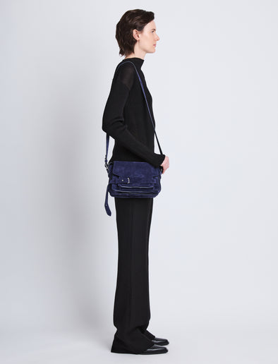 Image of model wearing Suede Beacon Saddle Bag in DEEP NAVY