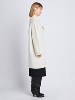 Side image of model wearing Ruth Coat In Knit Outerwear in ivory
