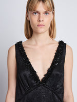 Detail image of model wearing Mira Dress In Embroidered Crushed Satin in black
