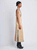 Side image of model wearing Mira Dress In Embroidered Crushed Satin in gold