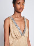 Detail image of model wearing Mira Dress In Embroidered Crushed Satin in gold