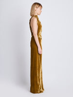 Side image of model wearing Faye Backless Twist Back Dress In Velvet in ochre