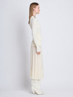 Side full length image of model wearing Agnes Henley Sweater in IVORY