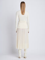 Back full length image of model wearing Agnes Henley Sweater in IVORY
