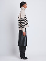 Side full length image of model wearing Sandra Turtleneck In Striped Doubleface Cashmere in OATMEAL MULTI