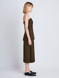 Side full length image of model wearing Corinne Strapless Top in DARK LODEN