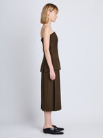 Side full length image of model wearing Corinne Strapless Top in DARK LODEN