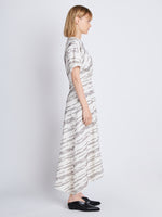 Side full length image of model wearing Vivienne Asymmetrical Dress in WHITE MULTI