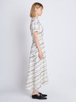 Side full length image of model wearing Vivienne Asymmetrical Dress in WHITE MULTI