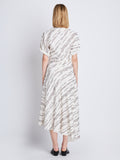 Back full length image of model wearing Vivienne Asymmetrical Dress in WHITE MULTI
