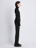 Side full length image of model wearing Sonia Top in BLACK