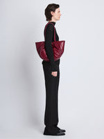 Image of model wearing Large Puffy Nappa Ruched Tote in GARNET