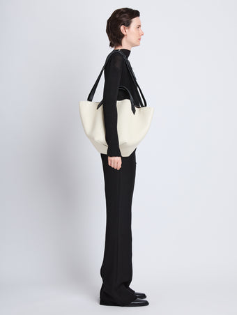  image of model wearing Large Chelsea Tote in ivory/black