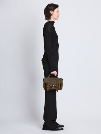 Image of model wearing Suede PS1 Tiny Bag in TEAK