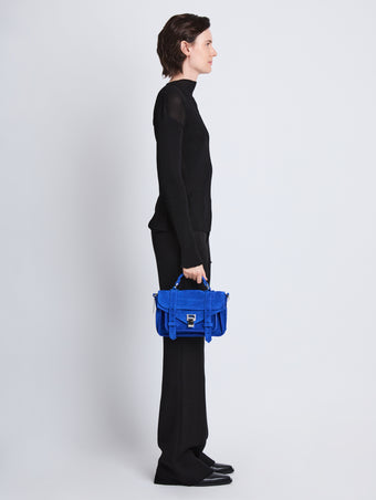 Image of model wearing Suede PS1 Tiny Bag in ELECTRIC BLUE