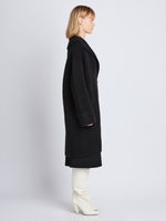 Side image of model wearing Ruth Coat In Knit Outerwear in black