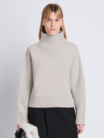 Cropped front image of model wearing Lofty Eco Cashmere Turtleneck Sweater in LIGHT GREY MELANGE