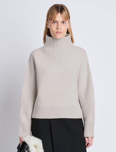 Cropped front image of model wearing Lofty Eco Cashmere Turtleneck Sweater in LIGHT GREY MELANGE