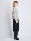 Side image of model wearing Lofty Eco Cashmere Turtleneck Sweater in LIGHT GREY MELANGE