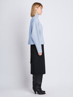 Side image of model wearing Alma Sweater In Lofty Eco Cashmere in pale blue