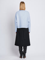 Back image of model wearing Alma Sweater In Lofty Eco Cashmere in pale blue