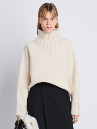Cropped front image of model wearing Alma Sweater In Lofty Eco Cashmere in ecru