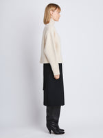 Side image of model wearing Alma Sweater In Lofty Eco Cashmere in ecru