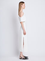 Side full length image of model wearing Rosa Off The Shoulder Dress in WHITE