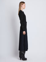Side full length image of model wearing Agnes Henley Sweater in BLACK