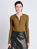 Cropped front image of model wearing Agnes Henley Sweater In Eco Superfine Merino in tobacco