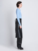 Side full length image of model wearing Agnes Henley Sweater in LIGHT BLUE