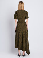 Back full length image of model wearing Vivienne Asymmetrical Dress in OLIVE MULTI