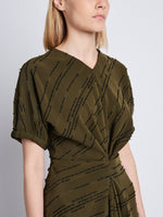 Detail image of model wearing Vivienne Asymmetrical Dress in OLIVE MULTI