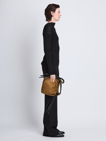Image of model wearing Nylon Drawstring Pouch in FATIGUE