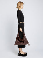 Image of model carrying Large Drawstring Shoulder Bag - MOCHA